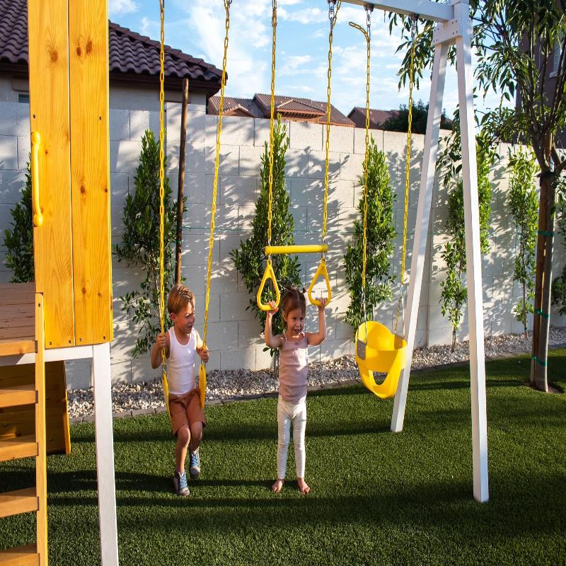 2 children playing on the  Avenlur Forest Playset swings.