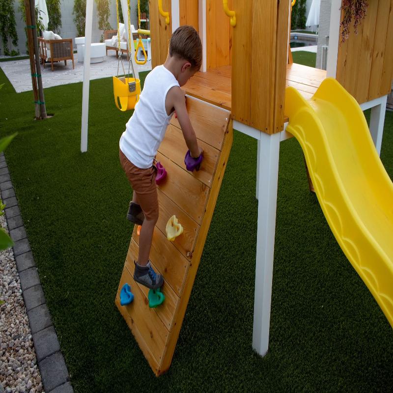 Child climbing the Avenlur Forest Playset climbing wall