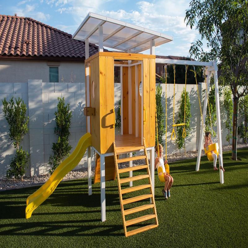 2 children swinging on the Avenlur Forest Playset.