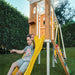 Young boy sliding down the Avenlur Forest  Playset slide.