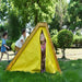 Child standing in between tent entry of the Avenlur Palm Playset